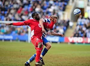 Images Dated 13th March 2010: Battling for Control: Akinde vs. Gunnarsson in the Intense Championship Showdown between Reading