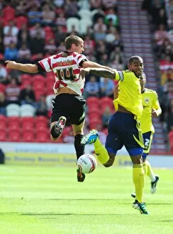 Images Dated 27th August 2011: Battling for the High Ball: Marvin Elliott vs. Tommy Spurr - Doncaster Rovers vs