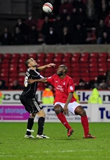 Images Dated 25th January 2011: Battling for Supremacy: Adebola vs. Caulker in Forest vs. Bristol City Championship Clash