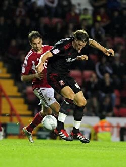 Images Dated 24th August 2011: Battling for Supremacy: Brett Pitman vs. Aden Flint in the 2011 League Cup Clash between Bristol