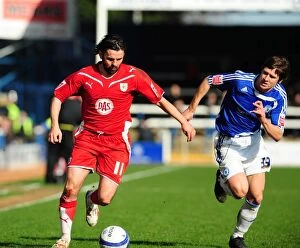 Images Dated 27th March 2010: Battling for Supremacy: Hartley vs. Simpson in the Championship Clash between Peterborough