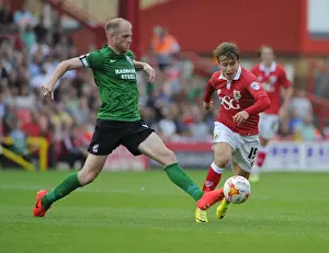 Battling for Supremacy: Luke Freeman vs Neil Bishop in Bristol City vs Scunthorpe United Football Match