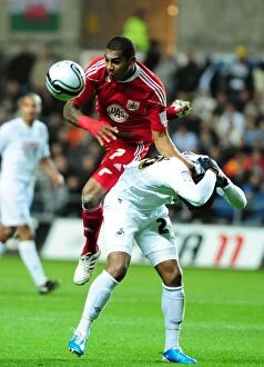 Images Dated 10th November 2010: Battling for Supremacy: Marvin Elliott vs. Kemy Agustien in Swansea City vs