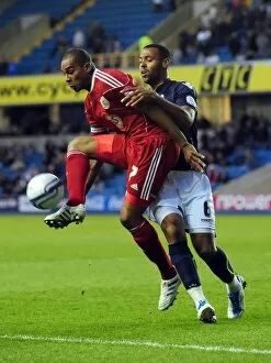 Images Dated 12th April 2011: Battling for Supremacy: Marvin Elliott vs. Liam Trotter in the Championship Clash between Millwall