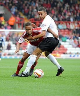 Images Dated 28th September 2013: Bobby Reid vs Craig Eastmond: A Football Rivalry Unfolds in Sky Bet League One - Bristol City vs