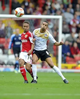 Bristol City V Colchester United Prints: Bobby Reid vs Craig Eastmond: Intense Battle for Possession in Bristol City vs Colchester United