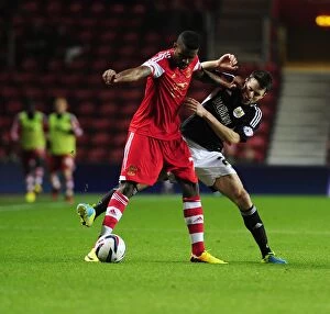Images Dated 24th September 2013: Brendan Moloney vs Guilherme do Prado: Intense Clash in Southampton vs Bristol City Football