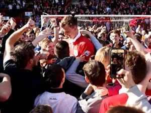 Bristol City Celebrates League One Title: Aden Flint Amidst Ecstatic Fans