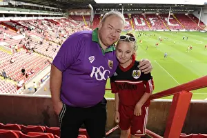 12 15 Prints: Bristol City Fan in Purple and Green Kit at Sheffield United's Bramal Lane for Sky Bet League One Opener