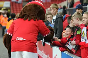 Bristol City V QPR Prints: Bristol City Fans Embrace Scrumpy Mascot at Ashton Gate during Sky Bet Championship Match against QPR (19/12/2015)