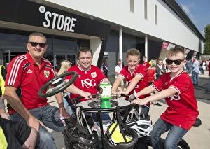 Images Dated 19th September 2015: Bristol City Fans Gather Around Children's Hospice South West's Seven-Seater Bike at Ashton Gate