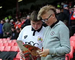 Framed Print : Bristol City Fans Preview Match Program Before Barnsley Clash at Ashton Gate Stadium Framed Print : Bristol City Fans Preview Match Program Before Barnsley Clash at Ashton Gate Stadium