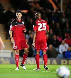 Images Dated 18th September 2012: Bristol City FC: James Wilson and Marvin Elliott Clash in Championship Match against Peterborough