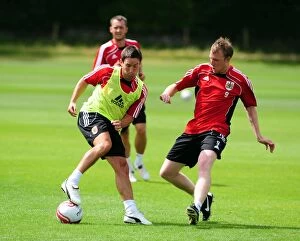 Images Dated 6th July 2010: Bristol City: Intense Training Moment - Johnson vs. Clarkson Battle for the Ball