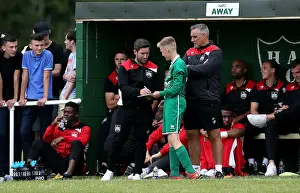 The Grove Prints: Bristol City Manager Lee Johnson Engages with Young Fan at Hengrove Athletic Pre-season Friendly