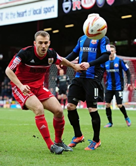 Bristol City vs Barnsley: Intense Battle for Possession in Npower Championship (Liam Kelly vs David Perkins)
