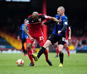 Images Dated 23rd February 2013: Bristol City vs Barnsley: Marvin Elliott Holds Off Ryan Tunnicliffe