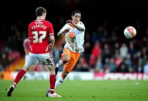 Images Dated 25th February 2012: Bristol City vs Blackpool: Intense Battle Between Thomas Ince and Stephen Pearson