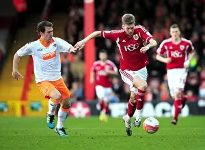 Images Dated 25th February 2012: Bristol City vs. Blackpool: Jon Stead Chases Down Danny Wilson