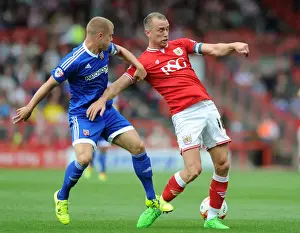 Bristol City vs. Brentford: Intense Battle for the Ball between Aaron Wilbraham and Jake Bidwell