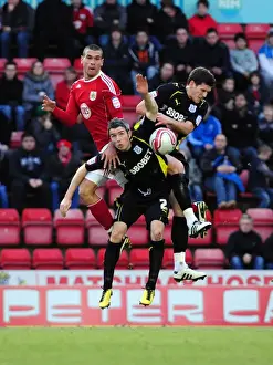 Bristol City vs. Cardiff City: Intense Battle for the Ball - Steven Caulker vs. Kevin McNaughton and Mark Hudson (Championship Football Match, 01/01/2011, Ashton Gate Stadium)