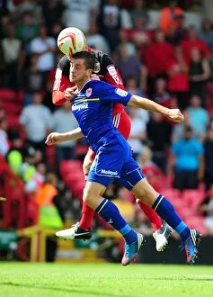 Images Dated 25th August 2012: Bristol City vs. Cardiff City: Ryan Taylor Seizes the Ball Over Andrew Taylor