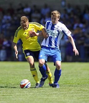 Images Dated 6th July 2013: Bristol City vs Clevedon Town: Intense Battle Between Rhys Jordan and Adi Adams