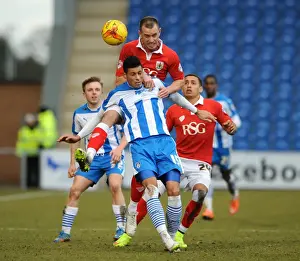 Colchester United V Bristol City Prints: Bristol City vs Colchester United: Intense Aerial Battle Between Aaron Wilbraham and Matthew Briggs
