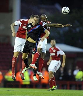 Images Dated 27th August 2013: Bristol City vs Crystal Palace: Intense Aerial Battle Between Marvin Elliott and Aaron Wilbraham
