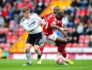 Images Dated 31st March 2012: Bristol City vs. Derby County: Intense Battle Between Kalifa Cisse and Steve Davies on the Field