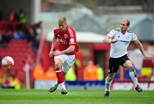 Images Dated 31st March 2012: Bristol City vs Derby County: Jon Stead vs Paul Green Battle for Possession at Ashton Gate