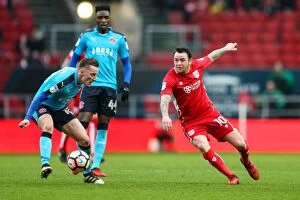 Images Dated 7th January 2017: Bristol City vs Fleetwood Town: Intense Moment as Lee Tomlin Clashes with George Glendon in The