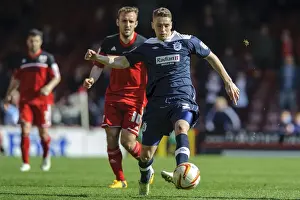 Town Prints: Bristol City vs. Huddersfield: Intense Moment as Liam Kelly Challenges Calum Woods