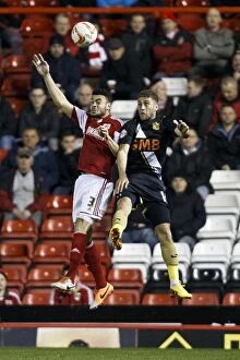 Images Dated 25th March 2014: Bristol City vs Port Vale: Intense Aerial Battle Between Derrick Williams and Gavin Tomlin