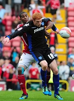 Images Dated 20th August 2011: Bristol City vs. Portsmouth: Intense Battle Between Marvin Elliott