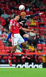 Images Dated 20th August 2011: Bristol City vs Portsmouth: Intense Battle for the High Ball between Lewin Nyatanga