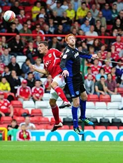 Images Dated 20th August 2011: Bristol City vs Portsmouth: James Wilson vs Dave Kitson Battle for the High Ball - Championship