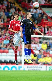 Images Dated 20th August 2011: Bristol City vs Portsmouth: James Wilson vs Luke Varney - Championship Clash at Ashton Gate