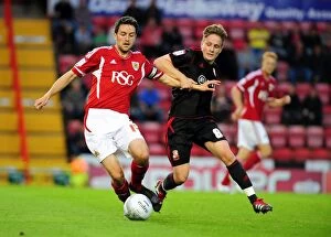 Bristol City v swindon town Collection: Bristol City vs Swindon Town: Cole Skuse vs Simon Ferry Battle in League Cup Match