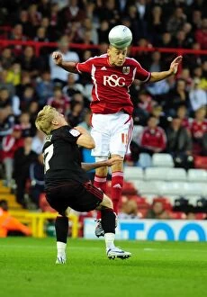Images Dated 24th August 2011: Bristol City vs Swindon Town: James Wilson vs Alan Connell in Intense League Cup Clash at Ashton