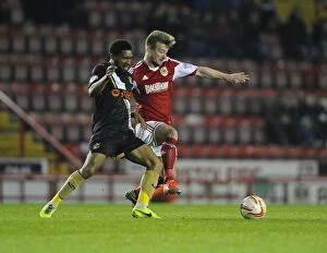 Images Dated 25th March 2014: Bristol City vs Swindon Town: Wade Elliott Fights for Ball in Intense Football Match