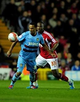 Images Dated 17th April 2012: Bristol City vs. West Ham: A Battle for Possession – Amougou vs