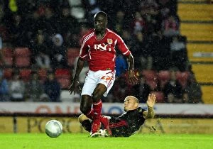 Images Dated 24th August 2011: Bristol City's Albert Adomah Fouled by Swindon Town's Alan McCormack - League Cup Clash, 2011