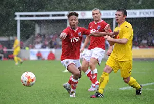 Brislington Prints: Bristol City's Bobby Reid Faces Off Against Brislington's James Peart in Pre-Season Clash