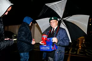 Images Dated 3rd November 2015: Bristol City's Buster Footman Braves the Rain for Poppy Appeal Donations at Ashton Gate Stadium
