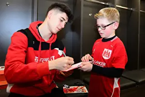 Bristol City V Fulham Prints: Bristol City's Callum O'Dowda Signs Autographs for Mascot Before Fulham Match