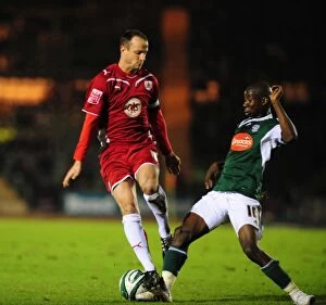 Images Dated 16th March 2010: Bristol City's Captain, Louis Carey, Clashes with Bradley Wright-Phillips of Plymouth Argyle