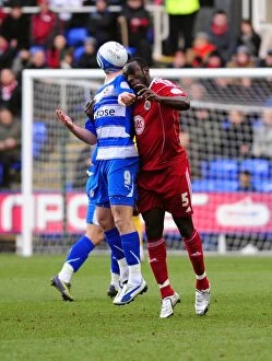 Images Dated 26th December 2010: Bristol City's Damion Stewart Outjumps Shane Long in Championship Clash at Reading, 2010