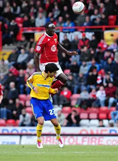 Bristol City V Derby County Prints: Bristol City's Damion Stewart Soars Above Derby County's Alberto Bueno in Championship Clash at Ashton Gate