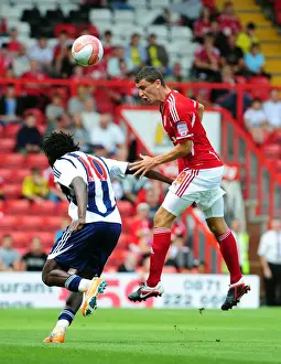 Season 11-12 Prints: Bristol City's James Wilson Outmuscles Somen Tchoyi in High Ball Clash